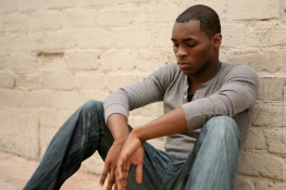 Depressed  African American Man Leaning Against Al